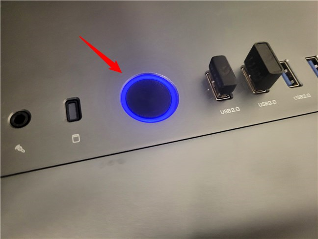 The power button on a desktop computer