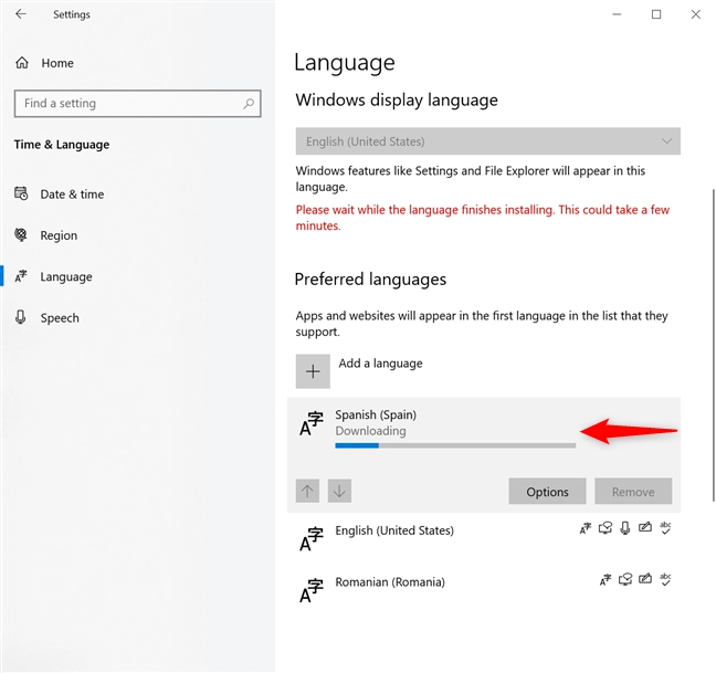 Wait for the Windows 10 language pack download to finish
