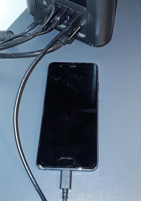 Huawei smartphone connected via a USB cable to a PC