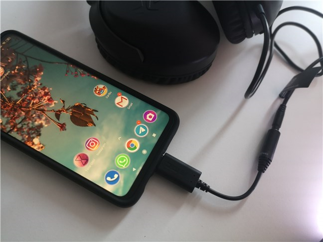 The ASUS AI Noise-Canceling Mic Adapter used with a smartphone