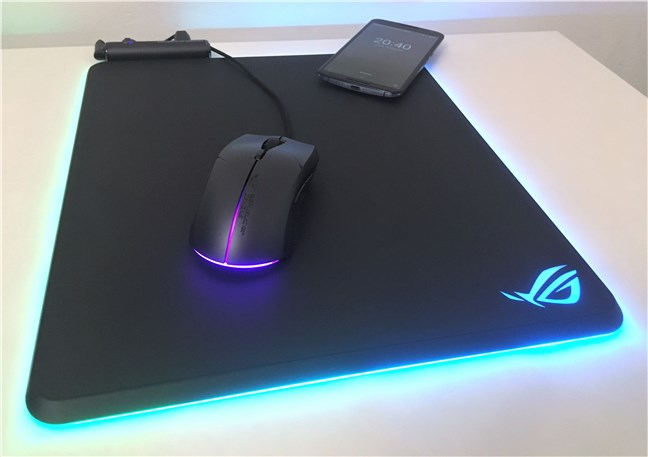 The ASUS ROG Balteus Qi mouse pad wirelessly charging a smartphone