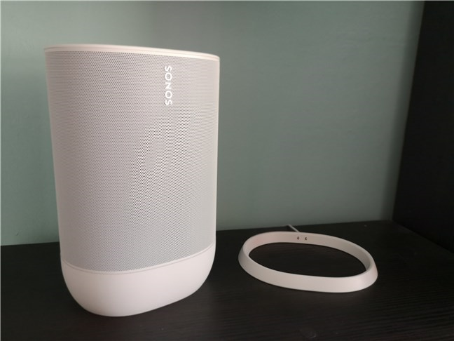 A Sonos Move speaker taken out of its charging cradle