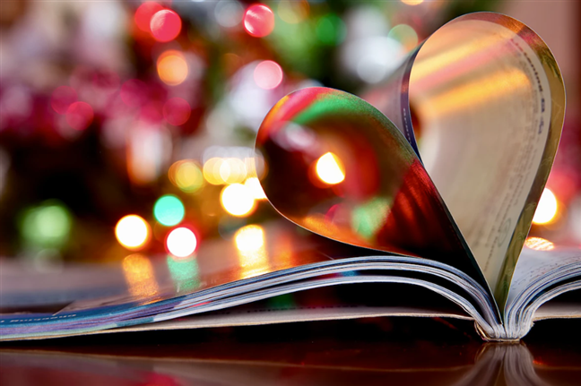 A book shaped like a heart next to a Christmas tree