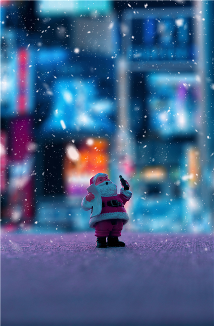 A toy Santa Clause is standing in the snow by IvÃ¡n DÃ­az