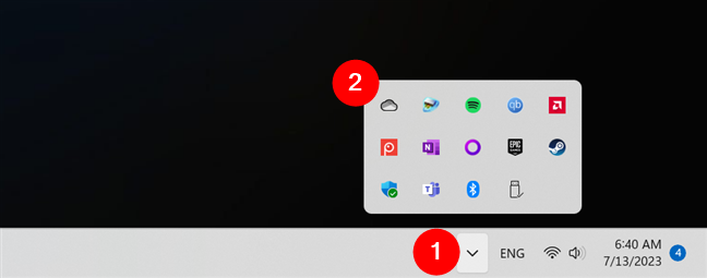 The OneDrive icon hidden inside the system tray apps list