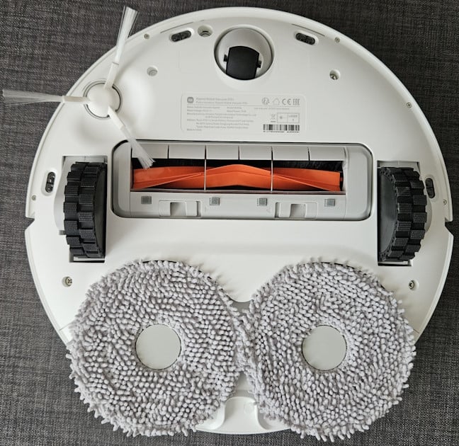 The robot with the mop pads and the side brush on