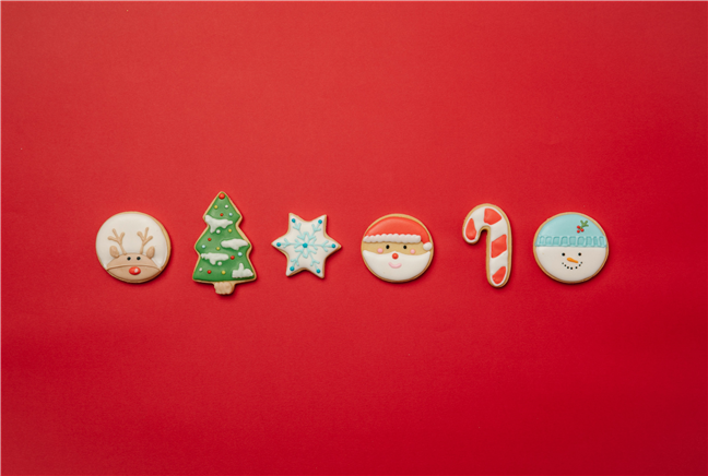 Yummy creative Christmas cookies placed on red surface by Laura James