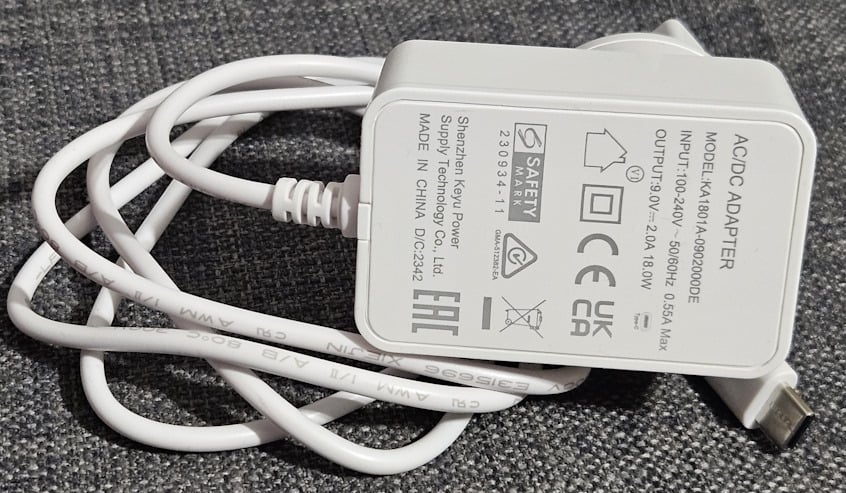 The power adapter for ASUS RT-AX57 Go