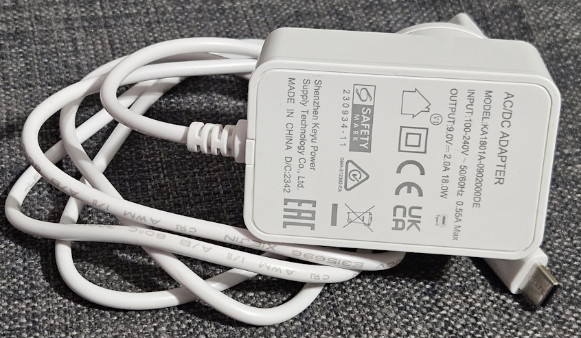 The power adapter for ASUS RT-AX57 Go