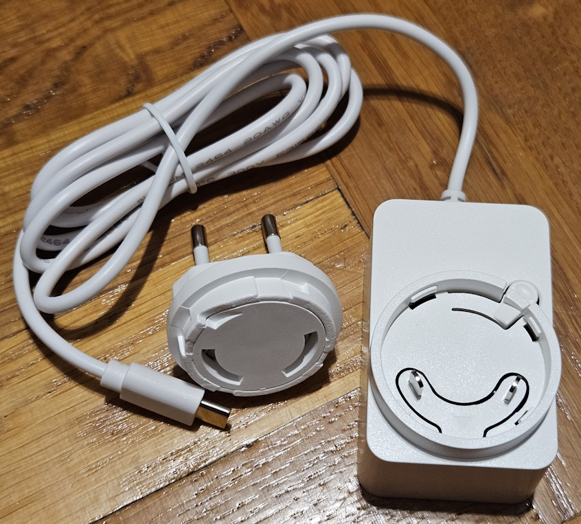 The power adapter includes plugs for EU and UK
