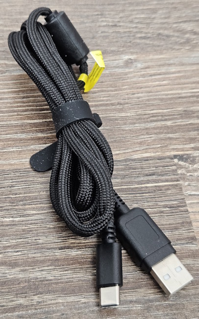The charging cable is covered in a soft textile material