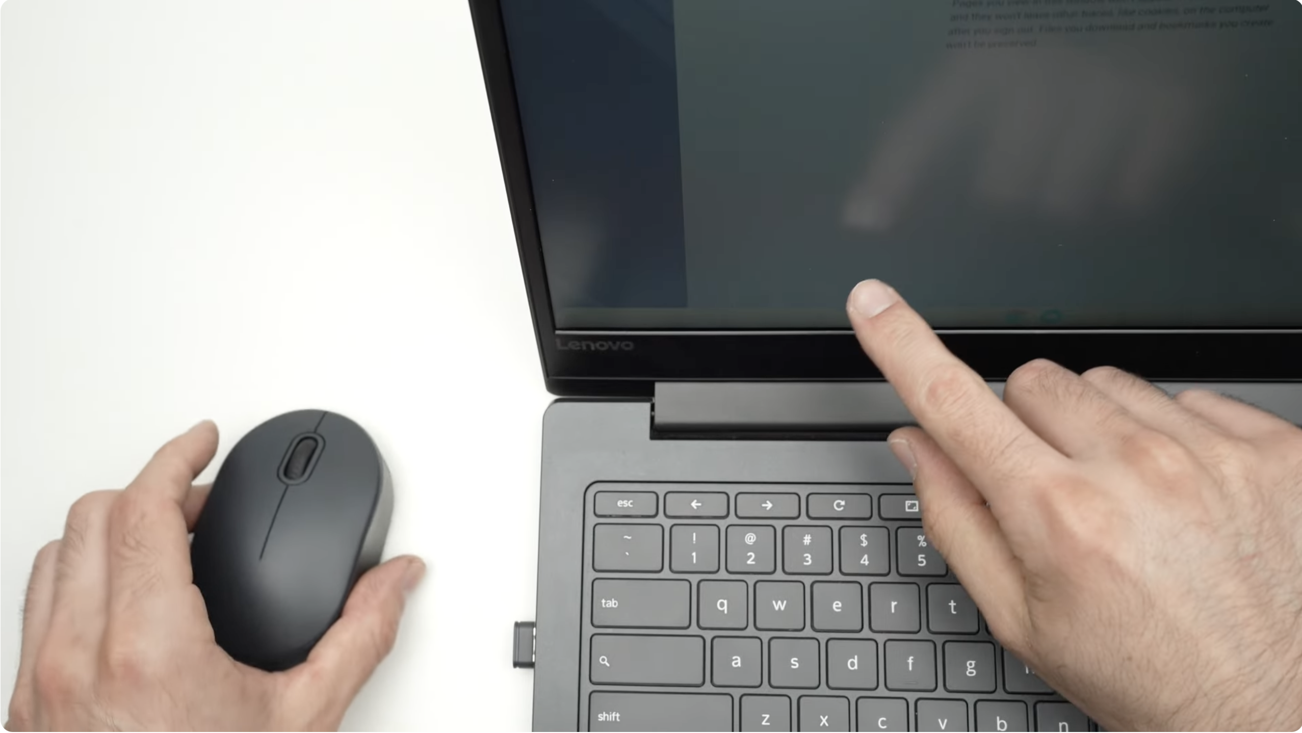 a picture of a hand pointing at the laptop screen