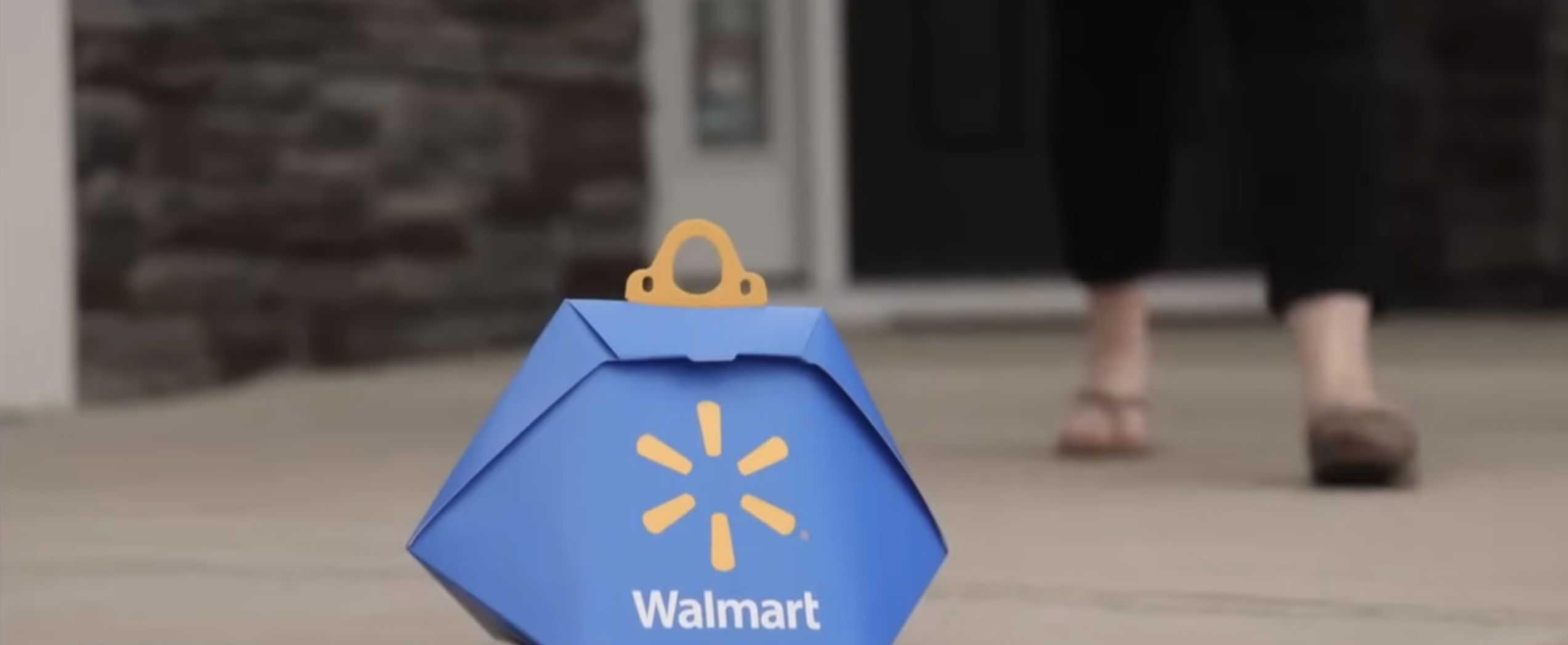 woman walking towards parcel left by drone