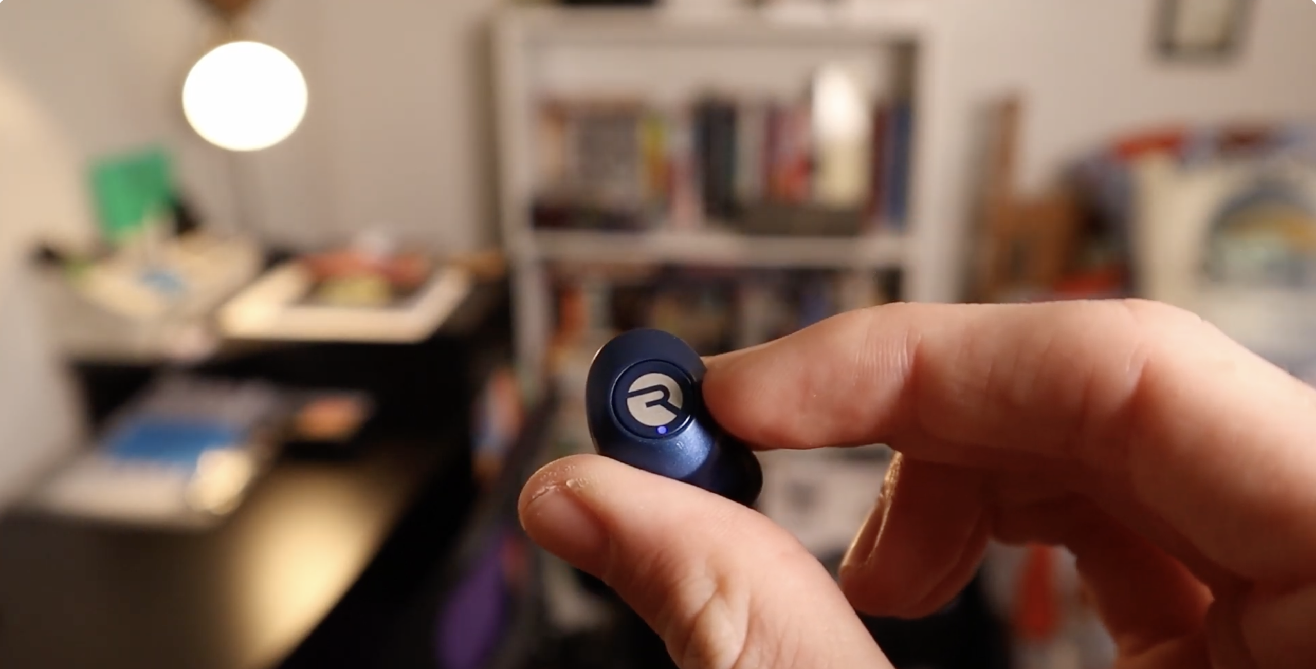 hand holding one raycon earpiece