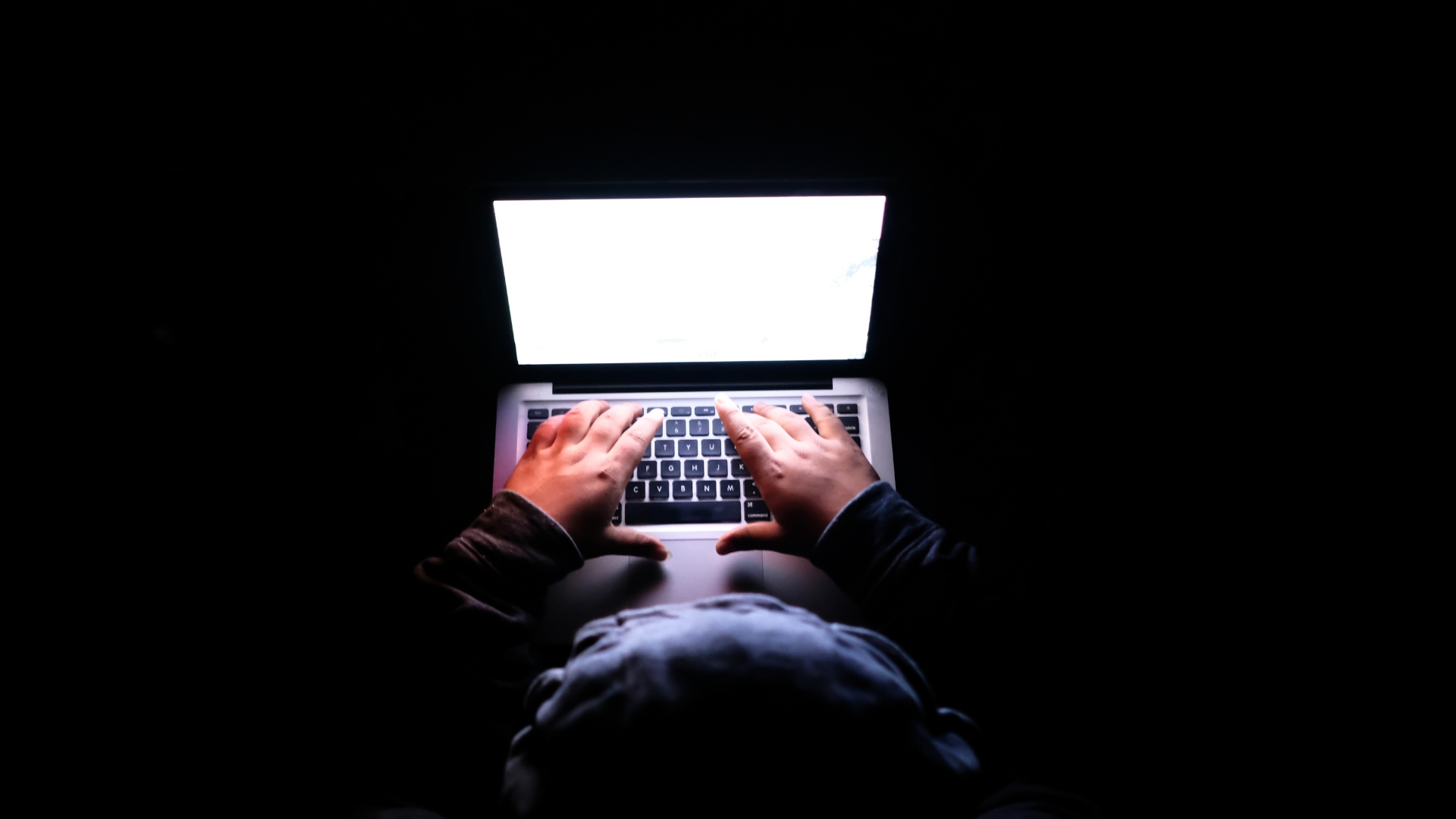 man on laptop attempting to hack