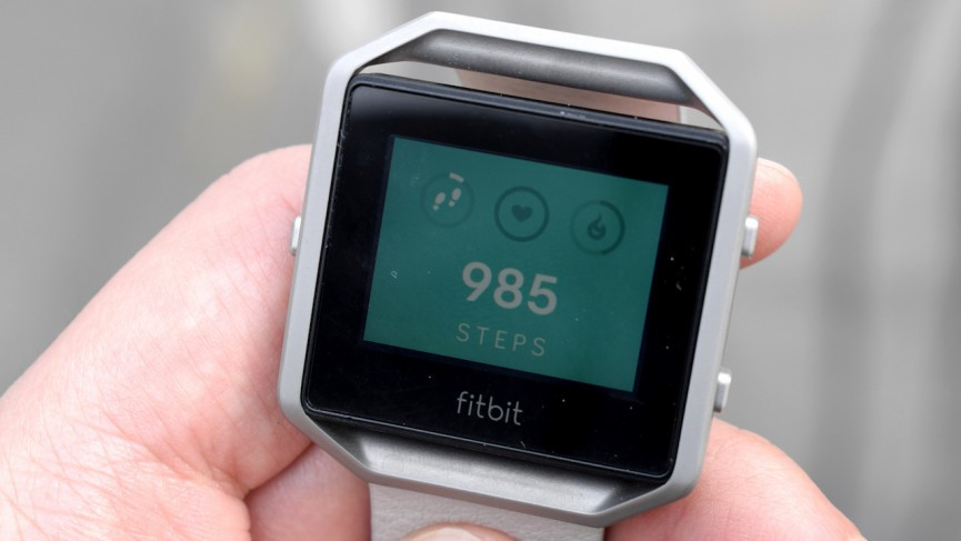 hand holding a fitbit watch