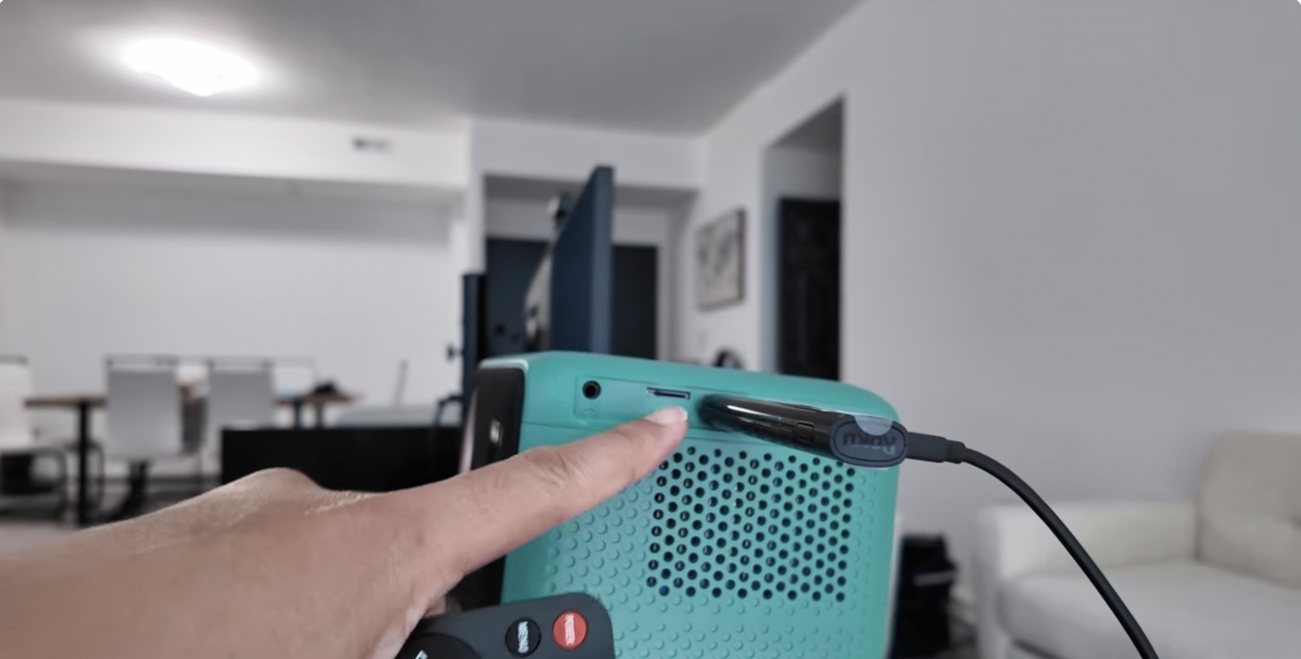 Roku streaming stick connected to a home projector on a table.
