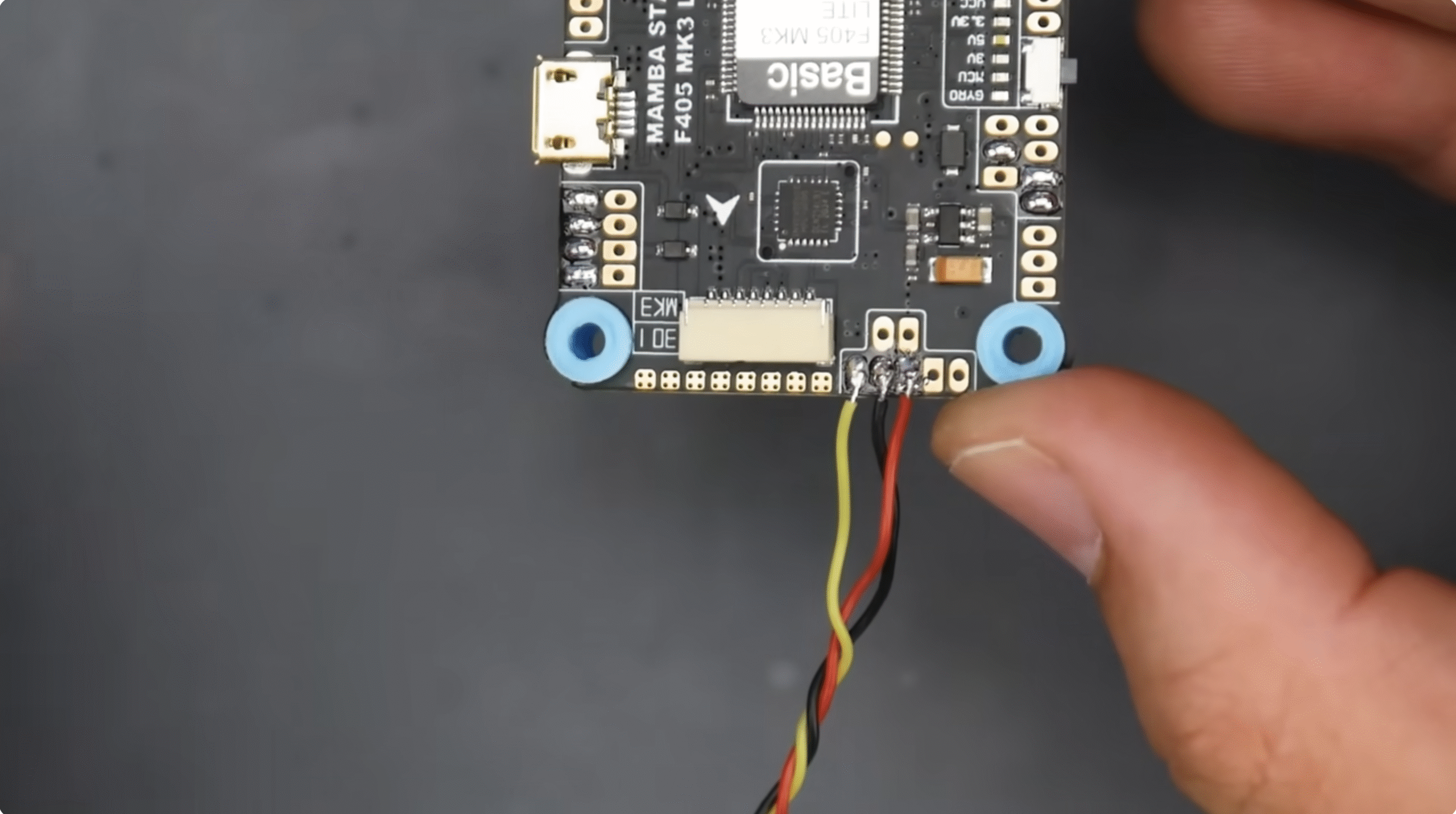 Flight controller with neatly routed motor wires.