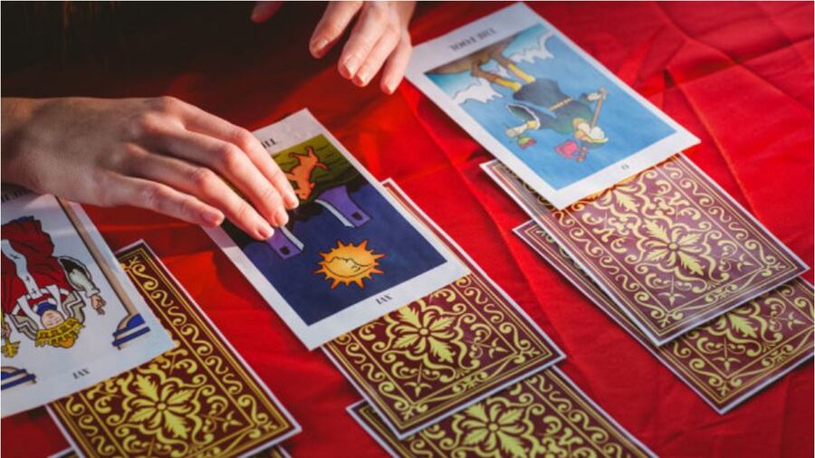 Close up of a hand drawing a tarot card from a deck