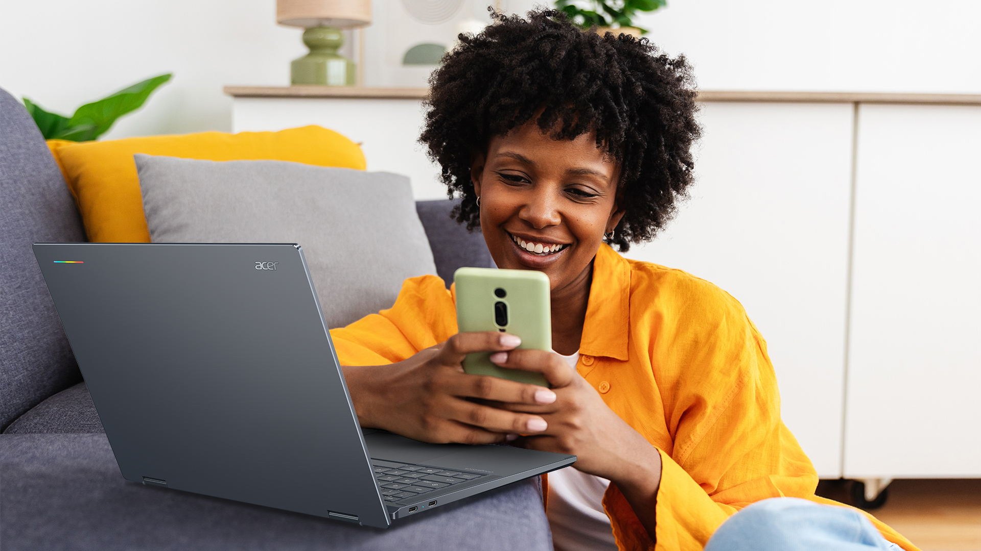 Woman on a couch with the Acer Googlebook 14 open on her lap
