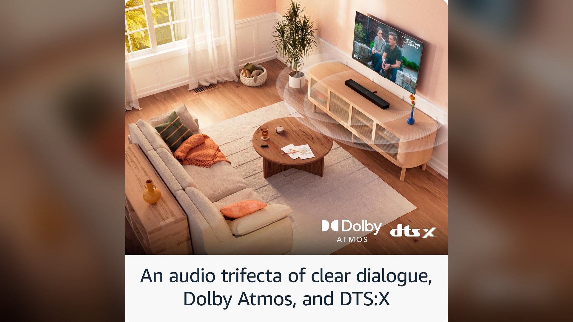 Soundbar under a wall-mounted television in a living room with Dolby Atmos and DTS:X badges