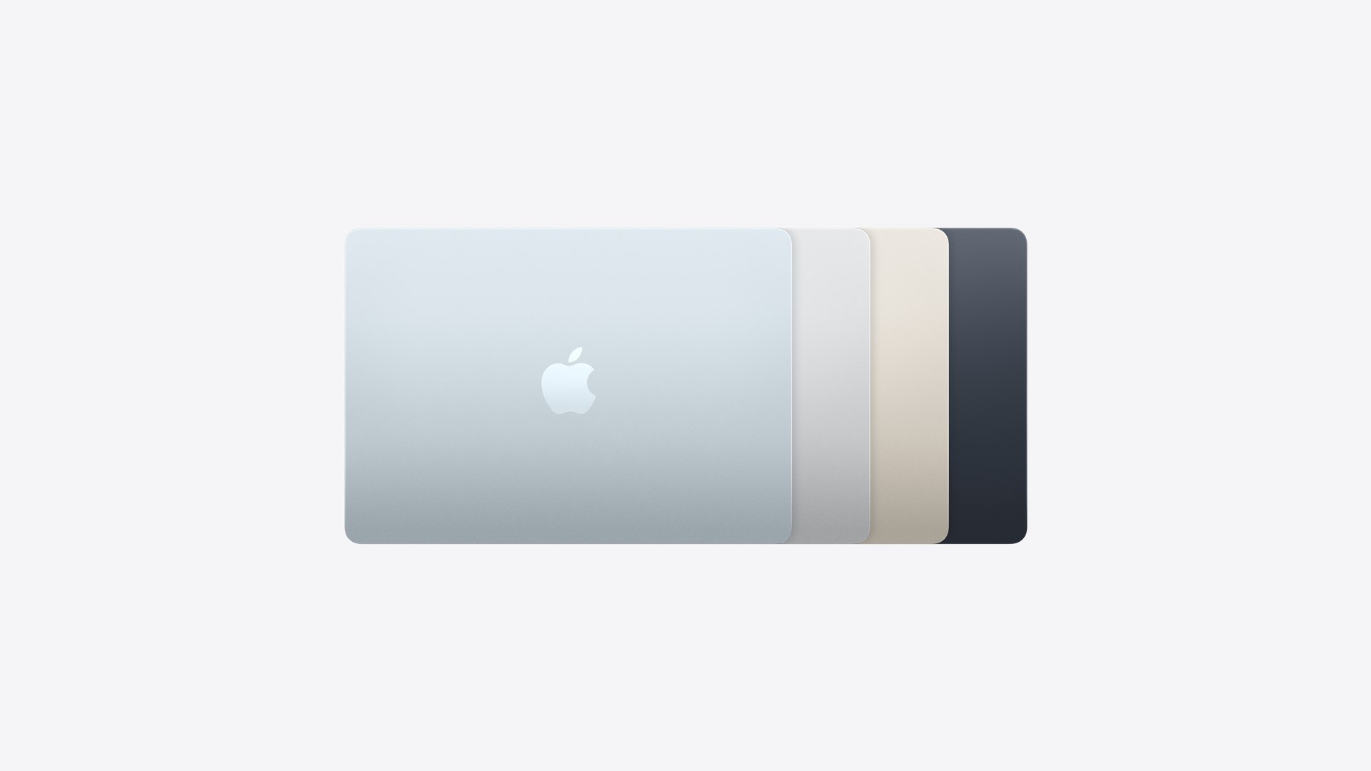 Four closed MacBook Air laptops stacked to show the Sky Blue, Silver, Starlight and Midnight finishes