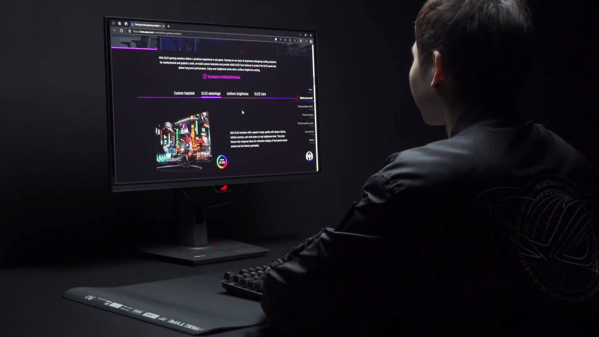 Person sitting in front of an ASUS ROG monitor in a dark room