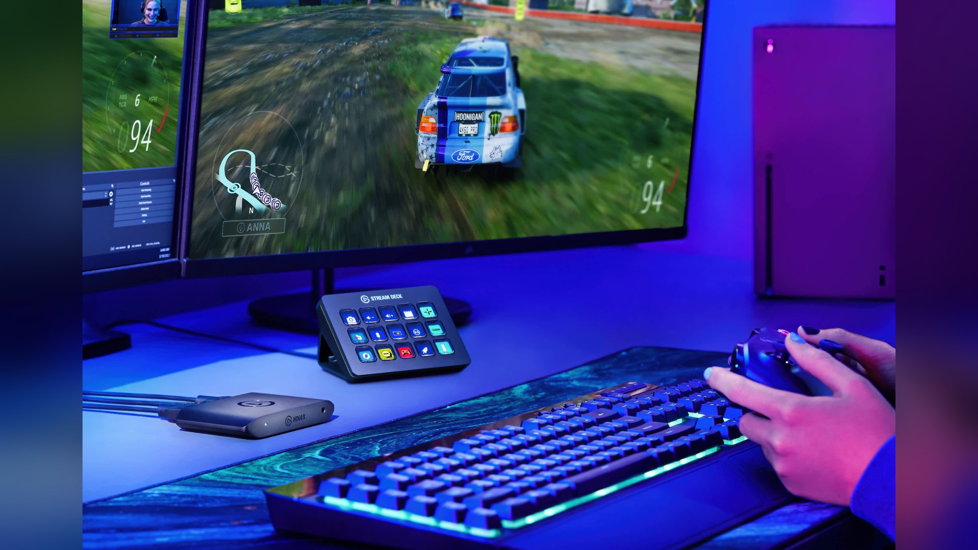 Stream Deck MK.2 on a desk next to a lit keyboard and a monitor