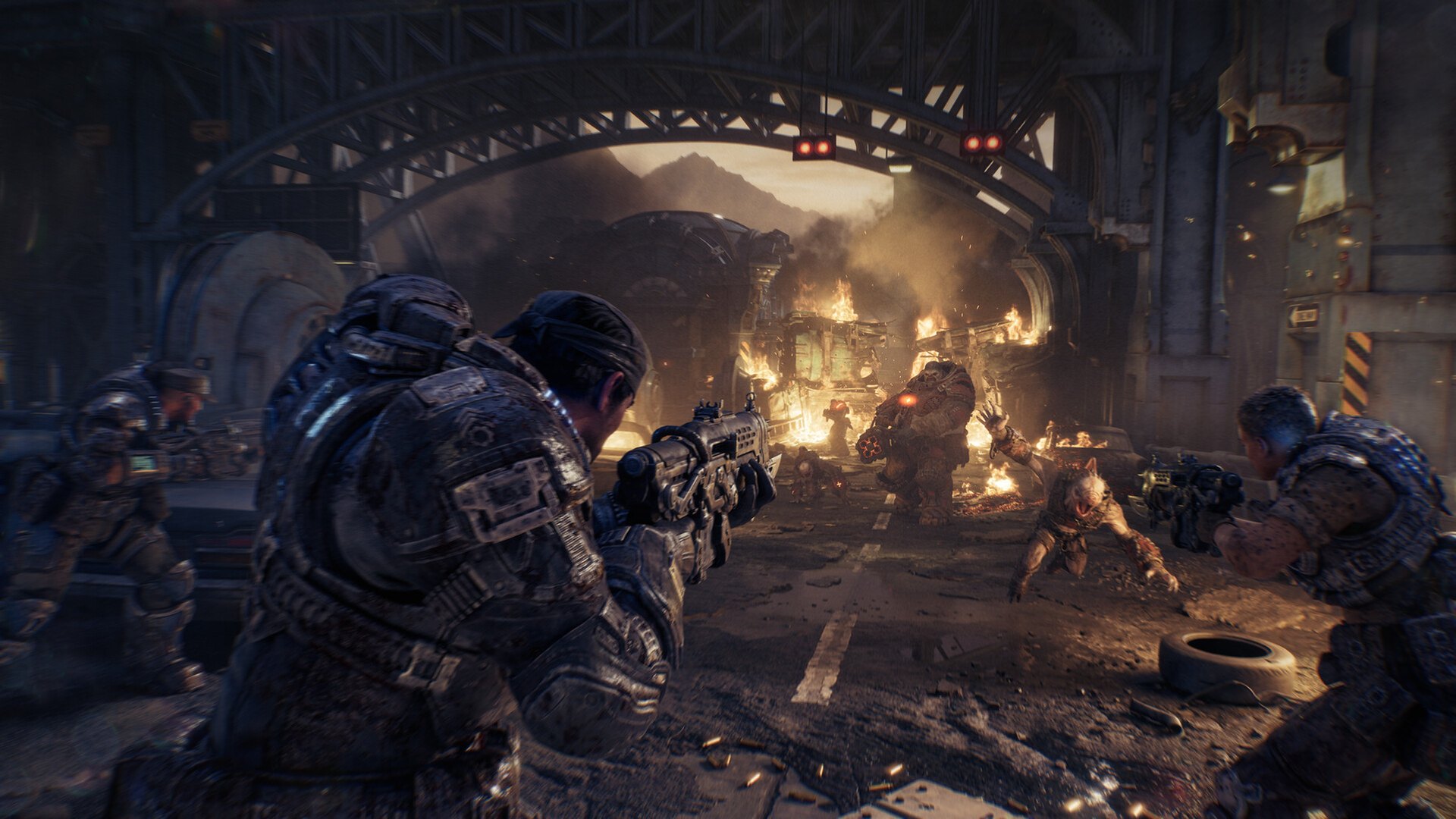 Soldiers firing from cover inside a burning industrial building in Gears of War: E-Day
