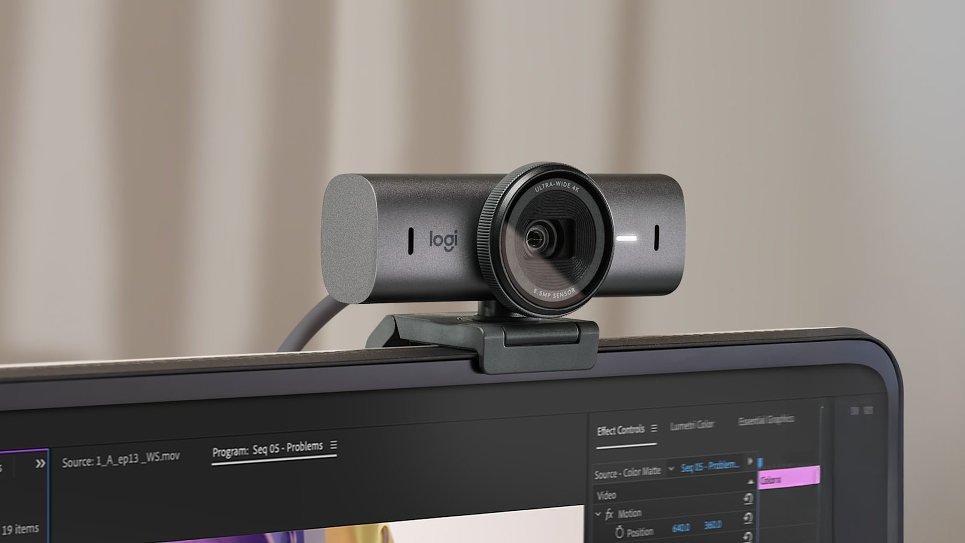 Logitech MX Brio webcam mounted on the top edge of a monitor