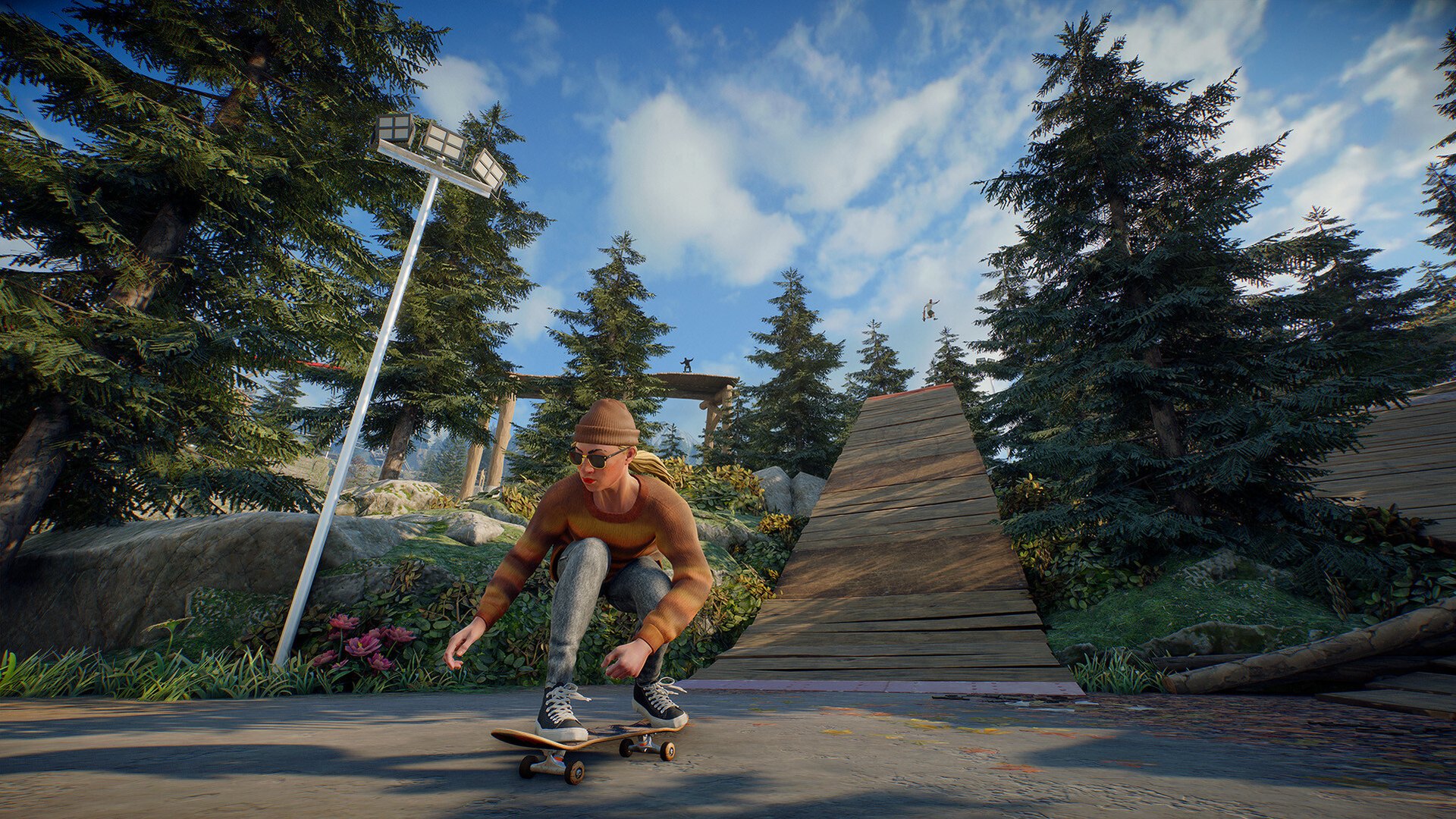 A skater riding a wooden ramp in a forested park in skate.