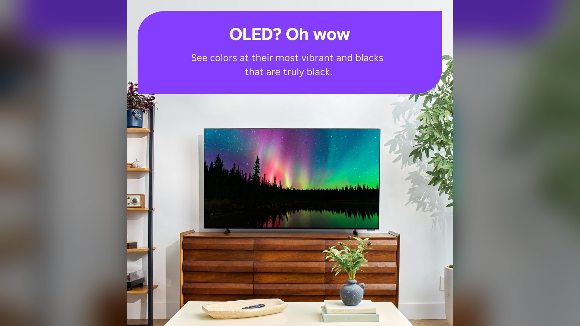 Roku Pro Series OLED TV mounted on a wall showing an aurora scene