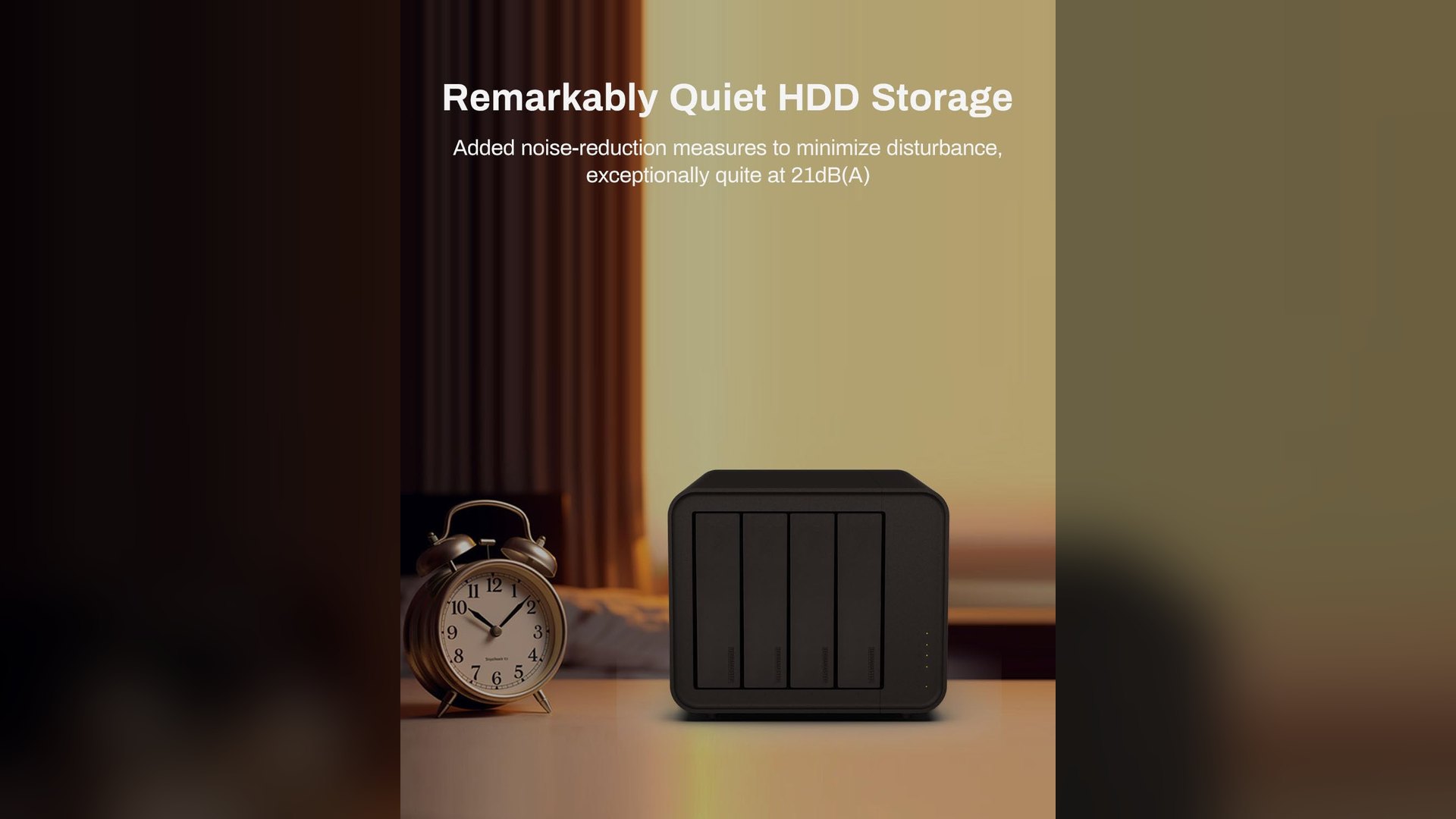 Black four-bay TerraMaster enclosure standing on a desk next to an alarm clock
