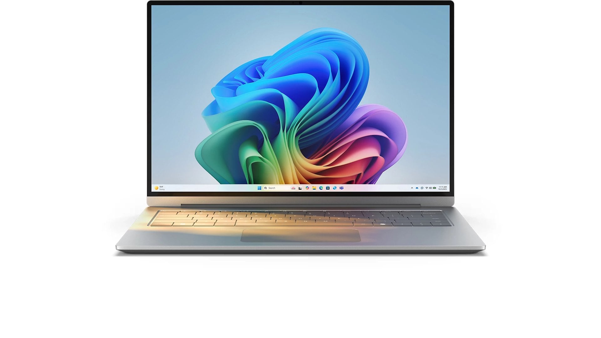 Silver laptop at an angle showing the Windows 11 bloom wallpaper